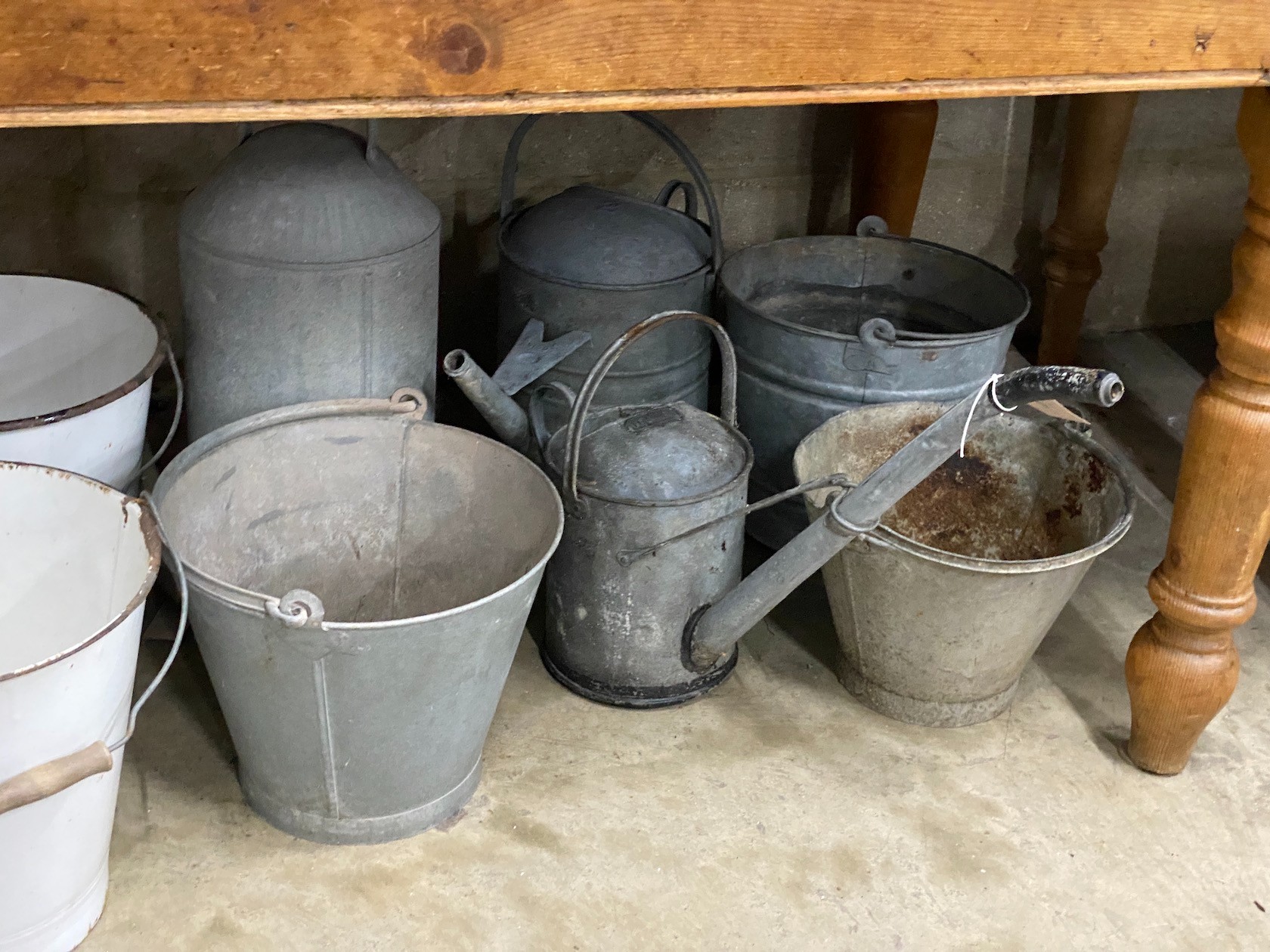 Ten galvanised and enamelled buckets, watering cans and feeder